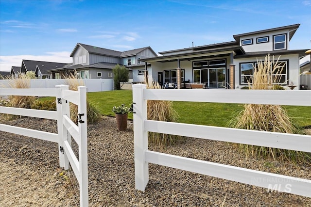 8749 W Suttle Lake Dr, Boise, ID 83714 - view of gate featuring a lawn and a fenced front yard