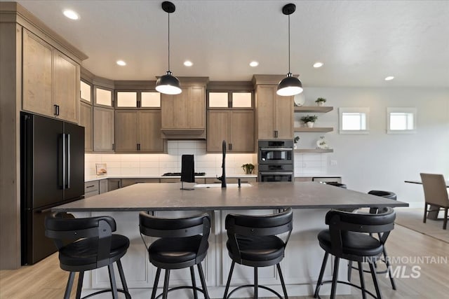8749 W Suttle Lake Dr, Boise, ID 83714 - kitchen with recessed lighting, double oven, backsplash, freestanding refrigerator, and light wood-style flooring