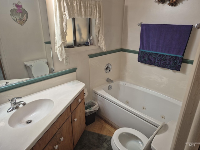 802 Foster Ave, Cottonwood, ID 83522 - bathroom featuring toilet, a tub with jets, vanity, and wood finished floors