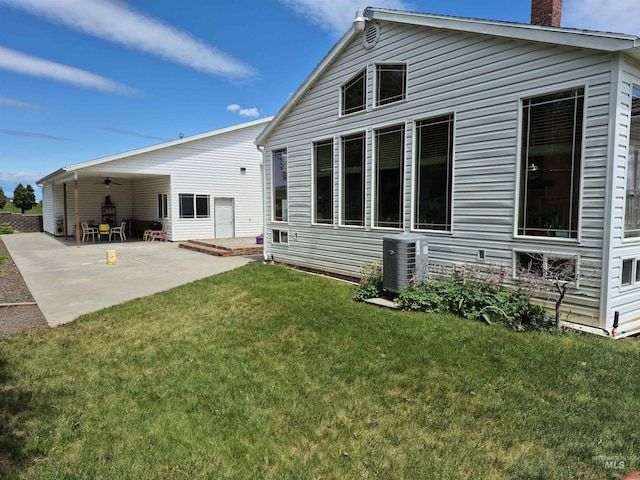802 Foster Ave, Cottonwood, ID 83522 - rear view of house featuring a chimney, a lawn, ceiling fan, a patio, and central AC unit
