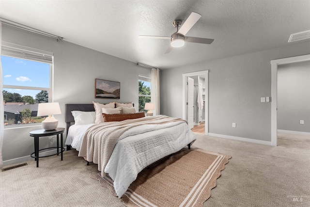 973 S Nautilus Ave, Boise, ID 83709 - bedroom with light carpet, a textured ceiling, ceiling fan, and ensuite bathroom