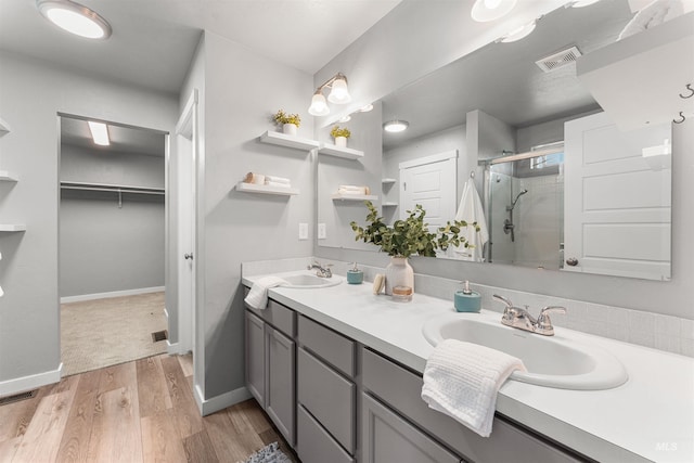 973 S Nautilus Ave, Boise, ID 83709 - bathroom featuring a shower stall, double vanity, wood finished floors, and a spacious closet