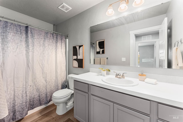 973 S Nautilus Ave, Boise, ID 83709 - full bath with wood finished floors, vanity, a shower with curtain, and a textured ceiling