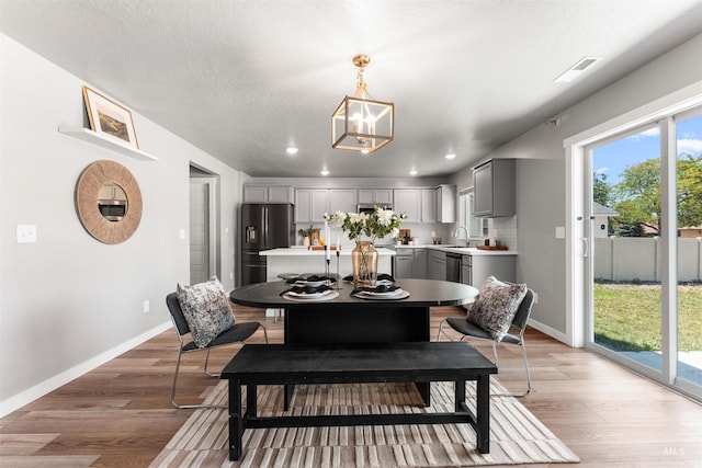 973 S Nautilus Ave, Boise, ID 83709 - dining room featuring light wood finished floors, recessed lighting, and a chandelier