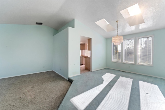 bedroom with lofted ceiling with skylight, a chandelier, visible vents, and baseboards