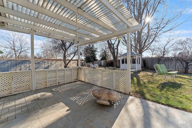 view of patio with an outbuilding, a fenced backyard, and a pergola