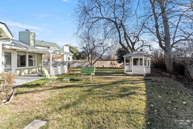 view of yard featuring a gazebo and a fenced backyard