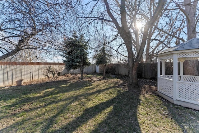 view of yard featuring a gazebo and a fenced backyard