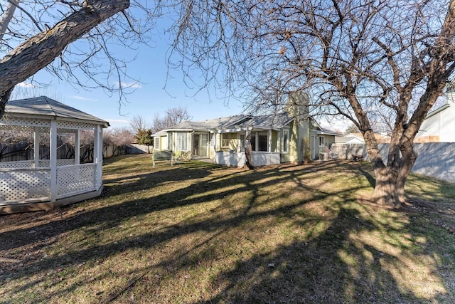 view of yard with fence and a gazebo