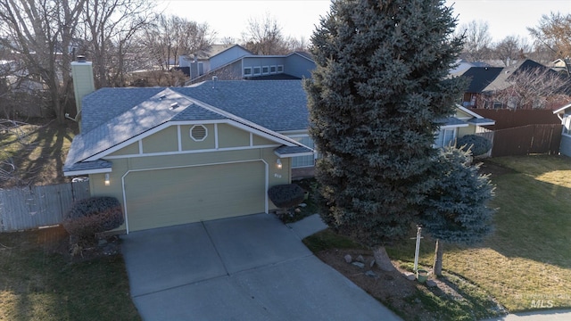 view of front of home with driveway, a shingled roof, an attached garage, and fence