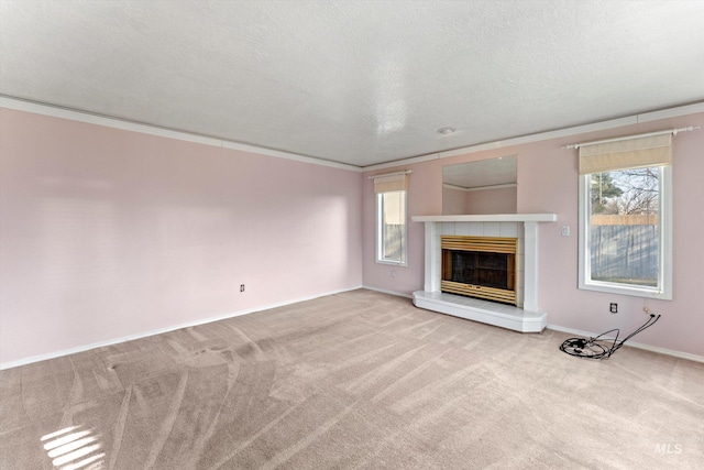 unfurnished living room with carpet, plenty of natural light, and a tile fireplace