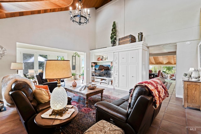 tiled living room featuring a chandelier, a towering ceiling, and wooden ceiling