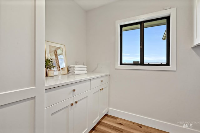 interior space featuring baseboards and light wood-style flooring