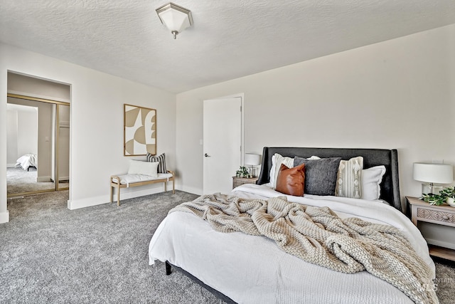 bedroom featuring baseboards, carpet floors, and a textured ceiling