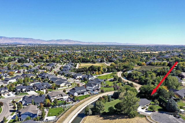 drone / aerial view featuring a residential view and a mountain view