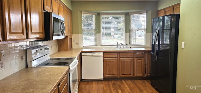 5720 N Oasis, Garden City, ID 83714 - kitchen featuring white appliances, a sink, backsplash, and brown cabinetry