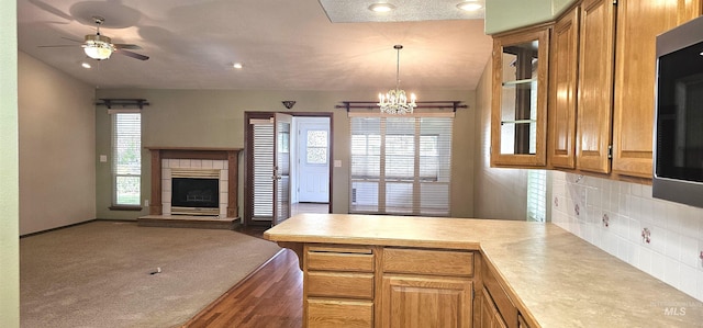 5720 N Oasis, Garden City, ID 83714 - kitchen featuring a peninsula, open floor plan, light countertops, a chandelier, and tasteful backsplash