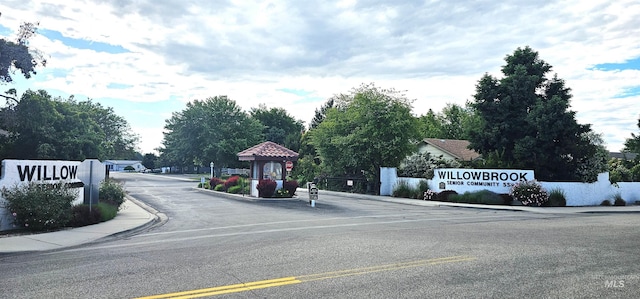 5720 N Oasis, Garden City, ID 83714 - view of asphalt road featuring curbs, sidewalks, and a gated entry