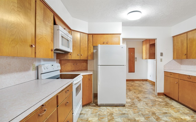 kitchen featuring a textured ceiling, white appliances, light countertops, and brown cabinetry
