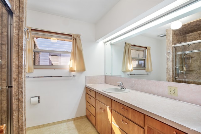 bathroom featuring a stall shower, vanity, and plenty of natural light