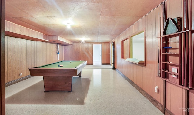 rec room featuring baseboards, wooden walls, and pool table