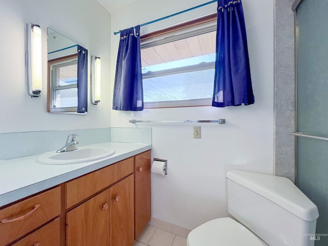 bathroom with vanity, toilet, and tile patterned flooring