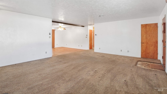 carpeted empty room with a textured ceiling and ceiling fan