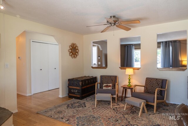 3929 N Shamrock Ave, Boise, ID 83713 - sitting room featuring wood finished floors, ceiling fan, baseboards, and arched walkways