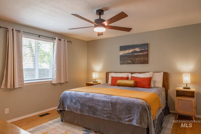 3929 N Shamrock Ave, Boise, ID 83713 - bedroom with wood finished floors, baseboards, and ceiling fan