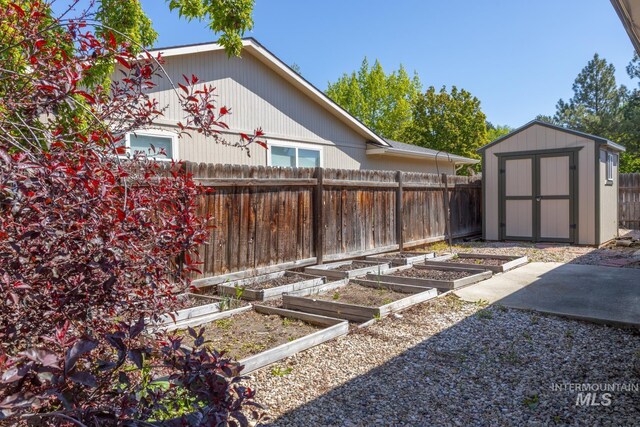 3929 N Shamrock Ave, Boise, ID 83713 - fenced backyard with a garden, a storage shed, and an outbuilding