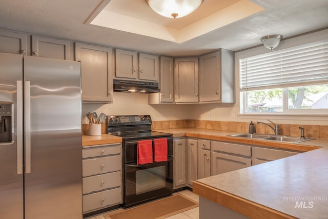 3929 N Shamrock Ave, Boise, ID 83713 - kitchen featuring stainless steel fridge with ice dispenser, black / electric stove, under cabinet range hood, a sink, and light countertops