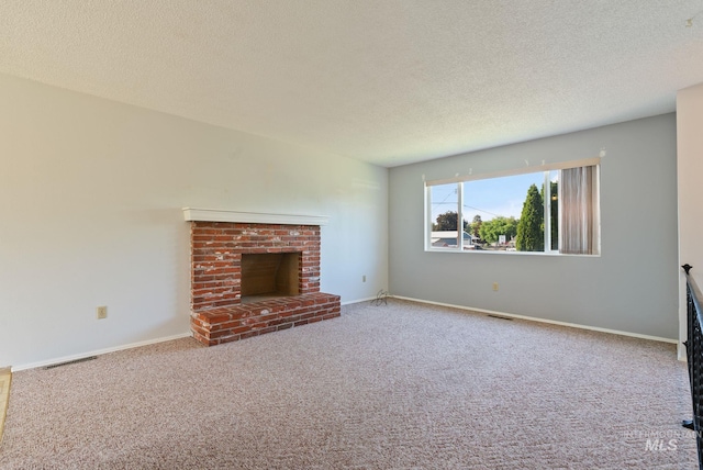2045 11th Ave, Clarkston, WA 99403 - unfurnished living room featuring a textured ceiling, carpet flooring, a brick fireplace, and baseboards
