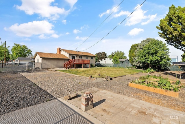 2045 11th Ave, Clarkston, WA 99403 - back of property with a vegetable garden, stairs, a wooden deck, and a patio