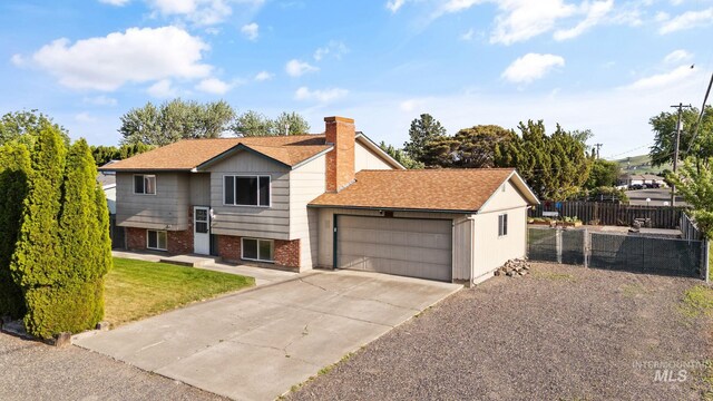 2045 11th Ave, Clarkston, WA 99403 - view of front of house featuring a garage, concrete driveway, a chimney, and brick siding