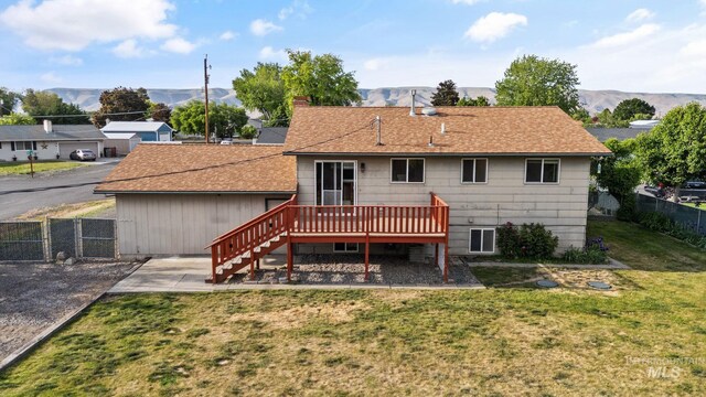 2045 11th Ave, Clarkston, WA 99403 - back of property with a deck with mountain view, stairs, roof with shingles, a patio area, and a gate