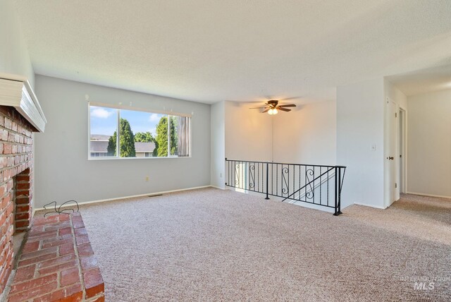 2045 11th Ave, Clarkston, WA 99403 - unfurnished living room with carpet floors, a ceiling fan, a brick fireplace, and baseboards