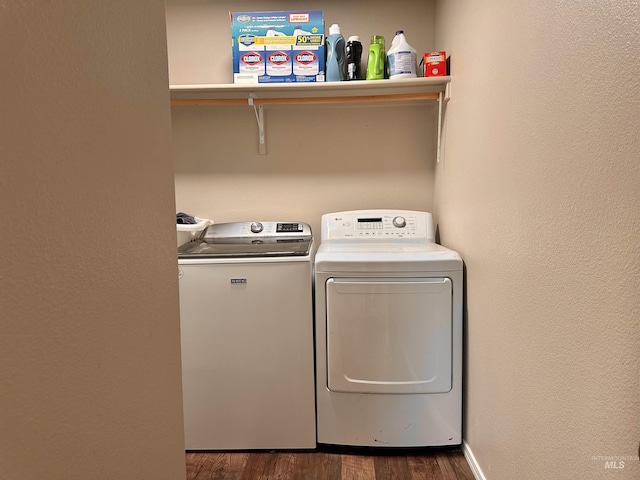 washroom featuring washing machine and dryer and dark hardwood / wood-style floors