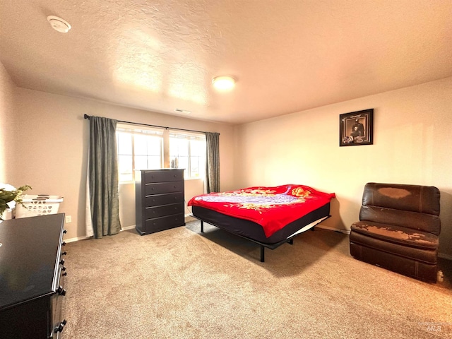 carpeted bedroom featuring a textured ceiling