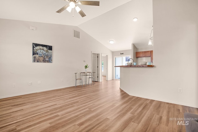 1522 Dana St, Twin Falls, ID 83301 - unfurnished living room with lofted ceiling, ceiling fan, and light wood-style floors