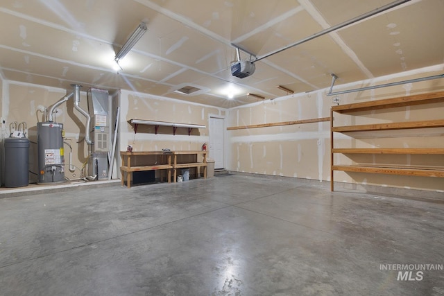 1522 Dana St, Twin Falls, ID 83301 - garage with gas water heater, a garage door opener, and heating unit
