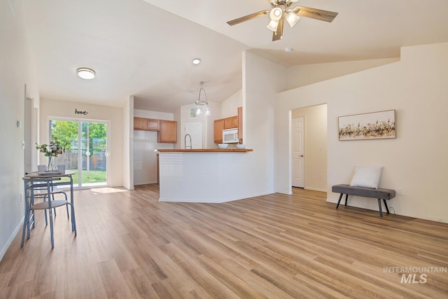 1522 Dana St, Twin Falls, ID 83301 - unfurnished living room with lofted ceiling, ceiling fan, and light wood-style floors