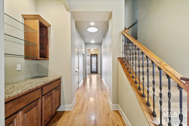 corridor with light wood-type flooring