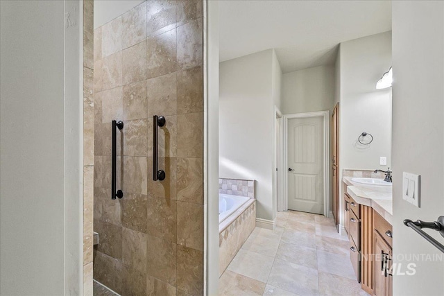 bathroom with plus walk in shower, vanity, and tile patterned floors