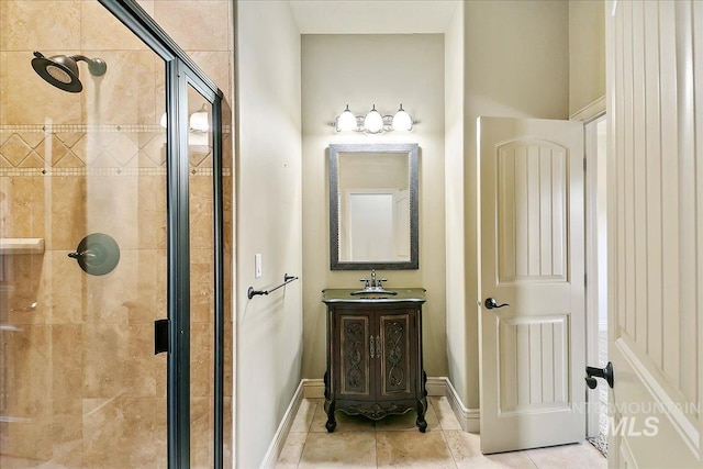 bathroom with tile patterned floors, vanity, and an enclosed shower