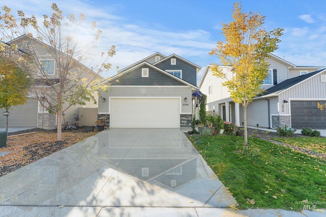 2318 Oxon St, Caldwell, ID 83605 - craftsman-style home featuring stone siding, concrete driveway, an attached garage, board and batten siding, and a front yard