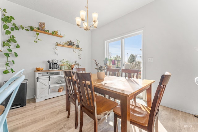 dining area featuring light hardwood / wood-style flooring and a notable chandelier