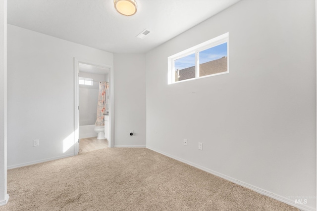 empty room with light carpet and a healthy amount of sunlight