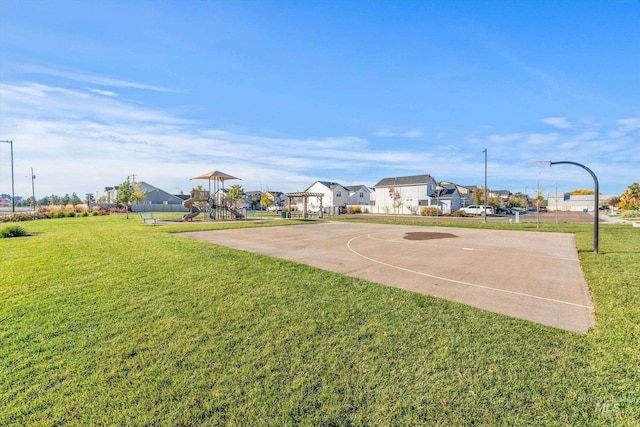 view of basketball court featuring a yard