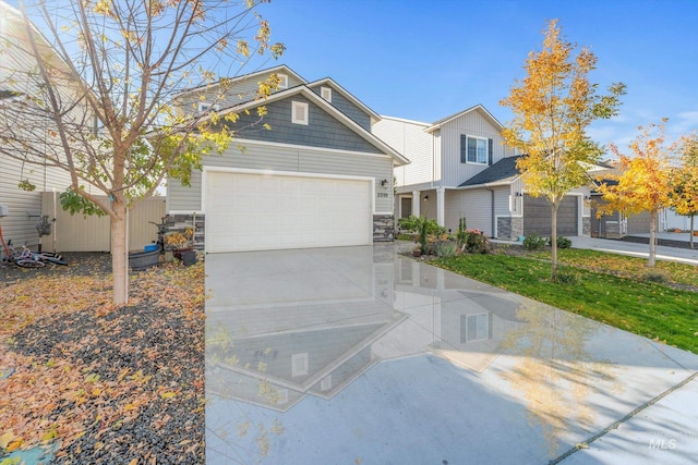 2318 Oxon St, Caldwell, ID 83605 - view of front facade featuring stone siding, an attached garage, and concrete driveway