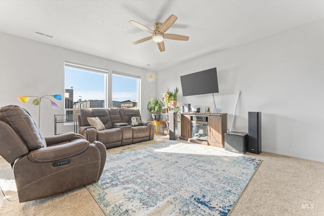 carpeted living room with ceiling fan